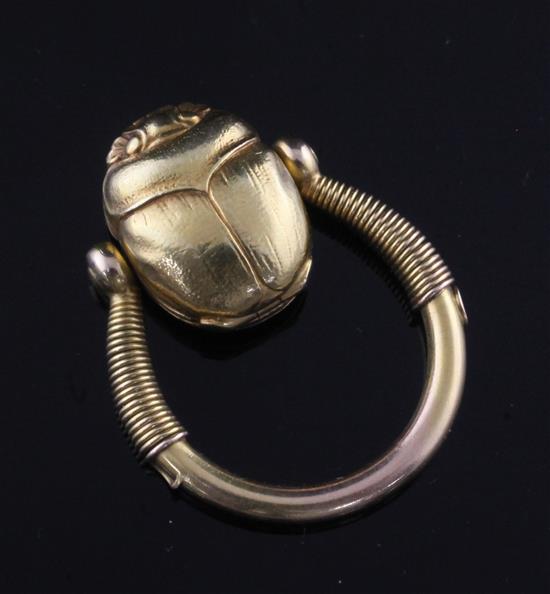 An early 20th century 14k gold swivelling Scarab locket ring, size N.